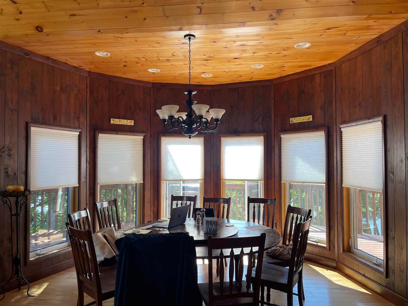Cellular shades around a cottage dining room with wood interior