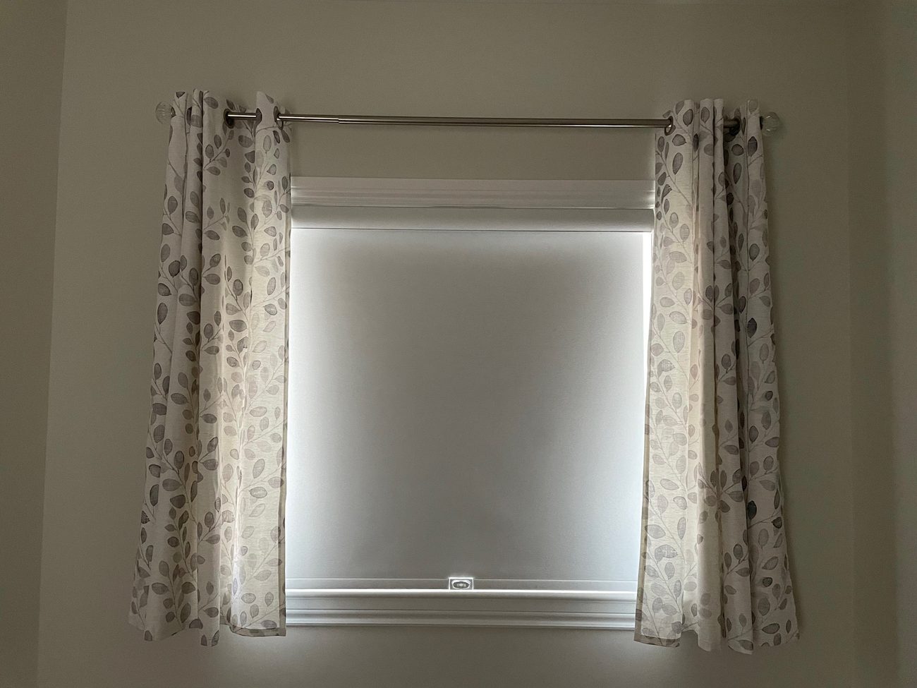 Roller shade paired with sheer curtains